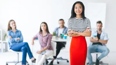 A group of employees are smiling into the camera