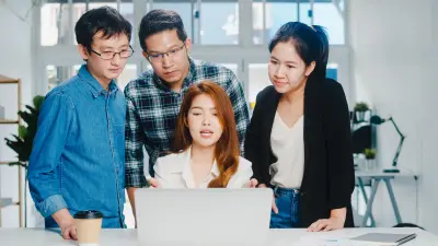A group of employees looking at a screen