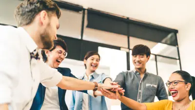 A group of employees smiling at each other