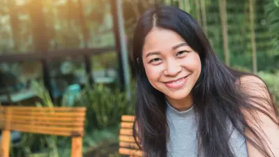 A woman is smiling into the camera