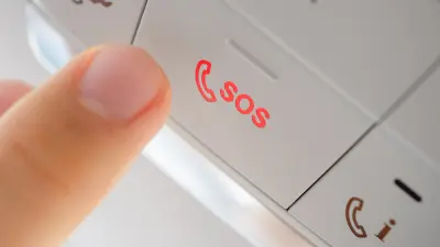 Person presses eCall button in a car