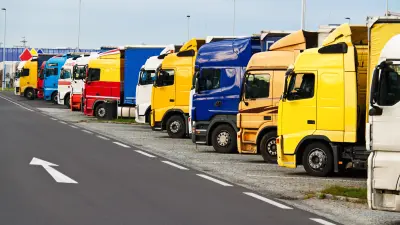 Several trucks are parked in a row next to each other