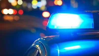 A police vehicle with blue lights on at night