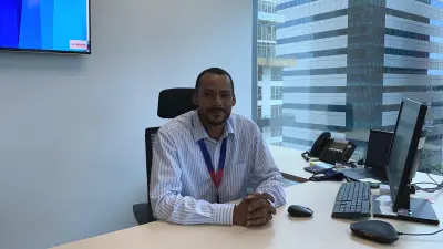Mamadou in front of a mural, looks at the camera